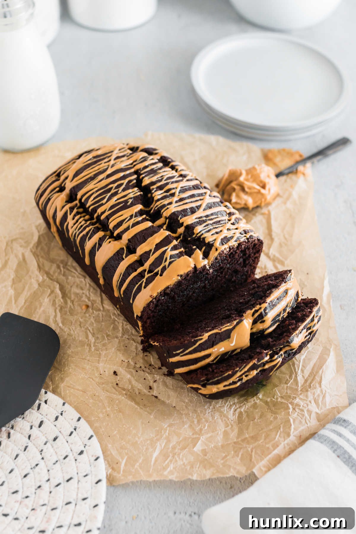 A loaf of chocolate peanut butter banana bread with slices cut.