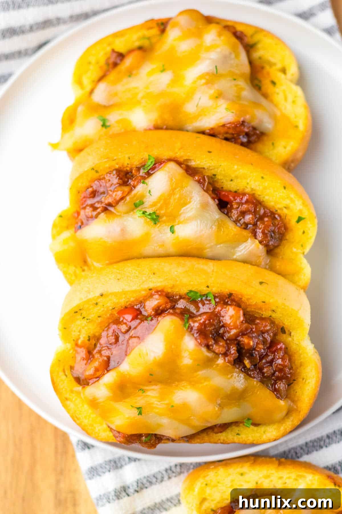 A platter of Texas toast sloppy joes, garnished and ready to be served.