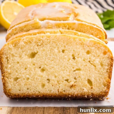 Cake cut into slices, showcasing the fluffy texture and glaze.