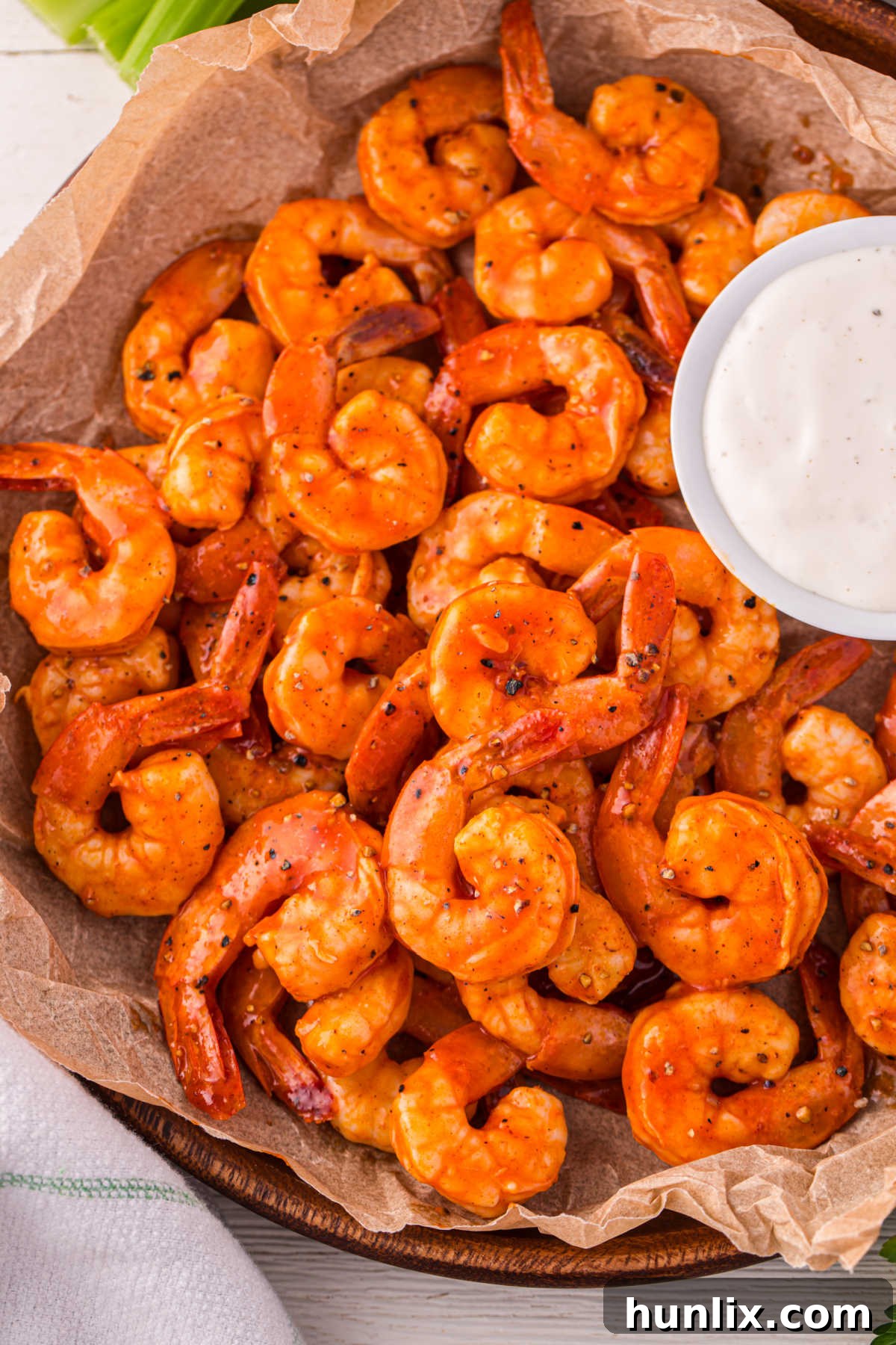 Crimson Glazed Shrimp 2 Buffalo shrimp in a basket with ranch dressing.
