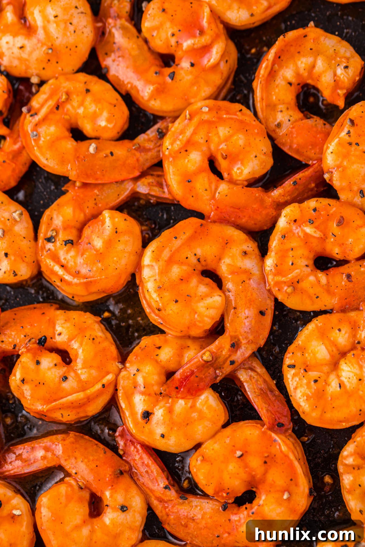 Crimson Glazed Shrimp 6 Buffalo shrimp on a baking sheet.