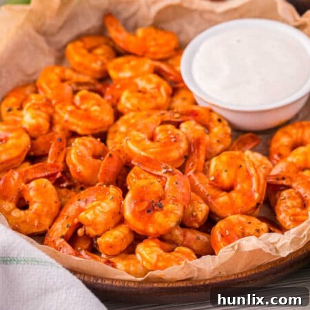Crimson Glazed Shrimp 9 Buffalo shrimp in a bowl with ranch dipping sauce.