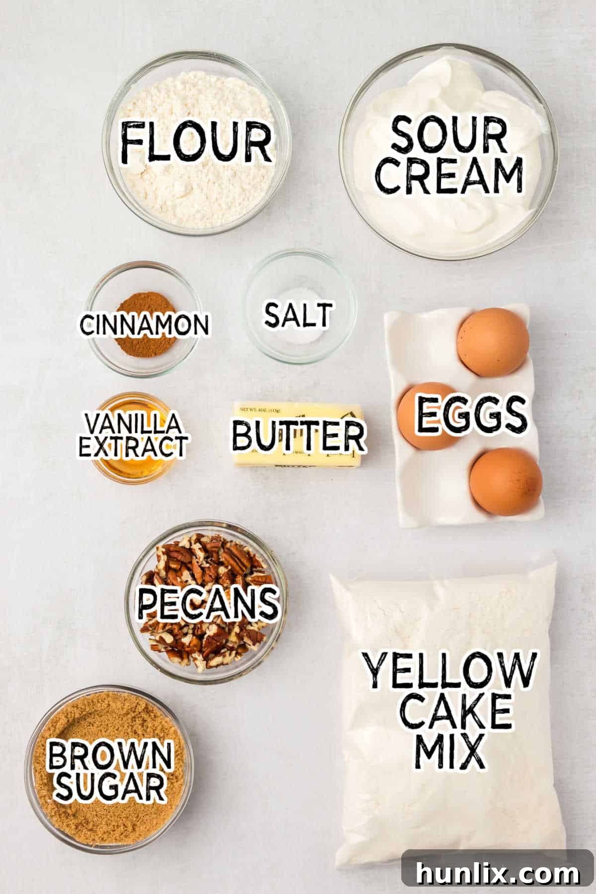 Various ingredients for coffee cake laid out on a white background.