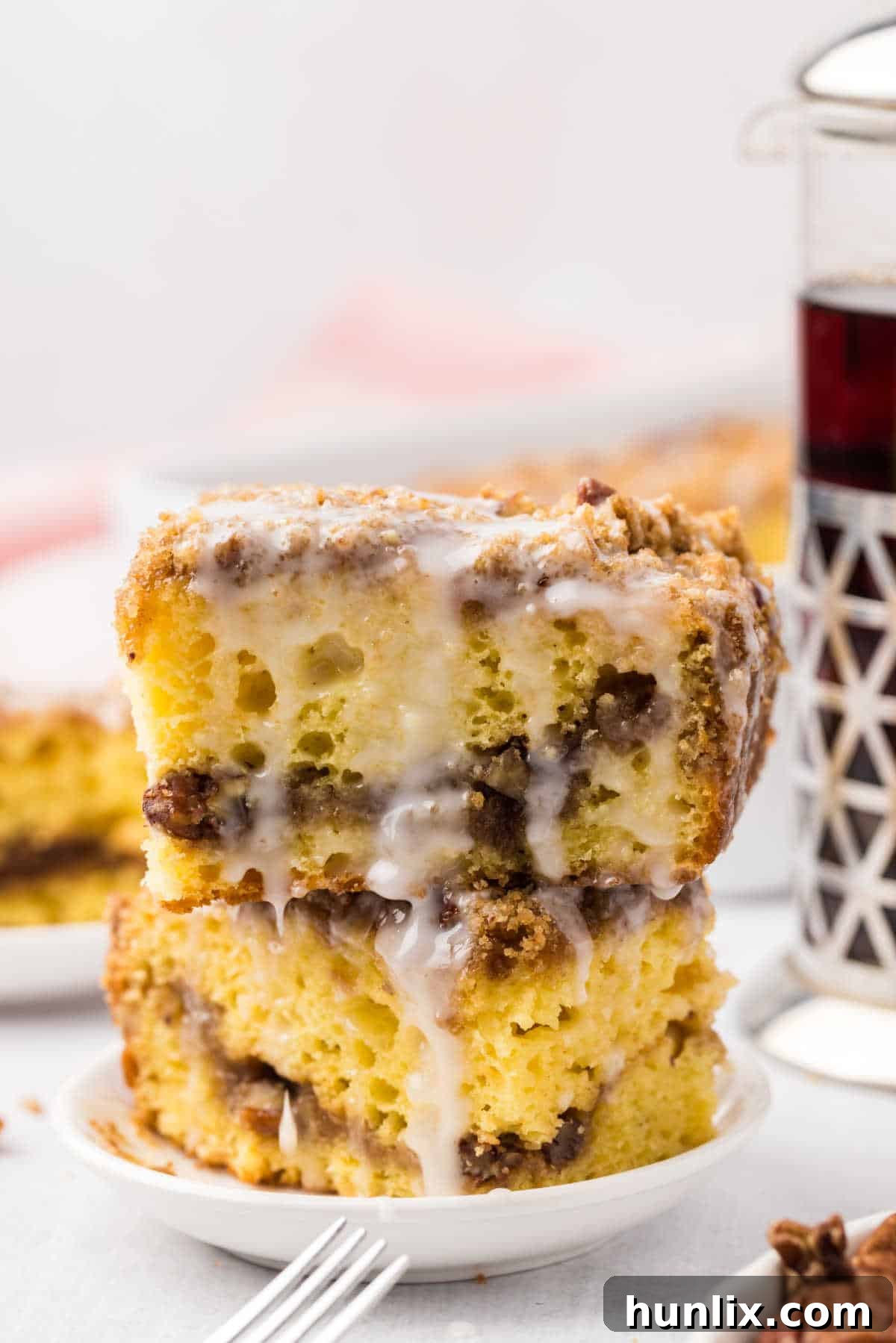A stack of three slices of coffee cake, showing the layers of cake and streusel.