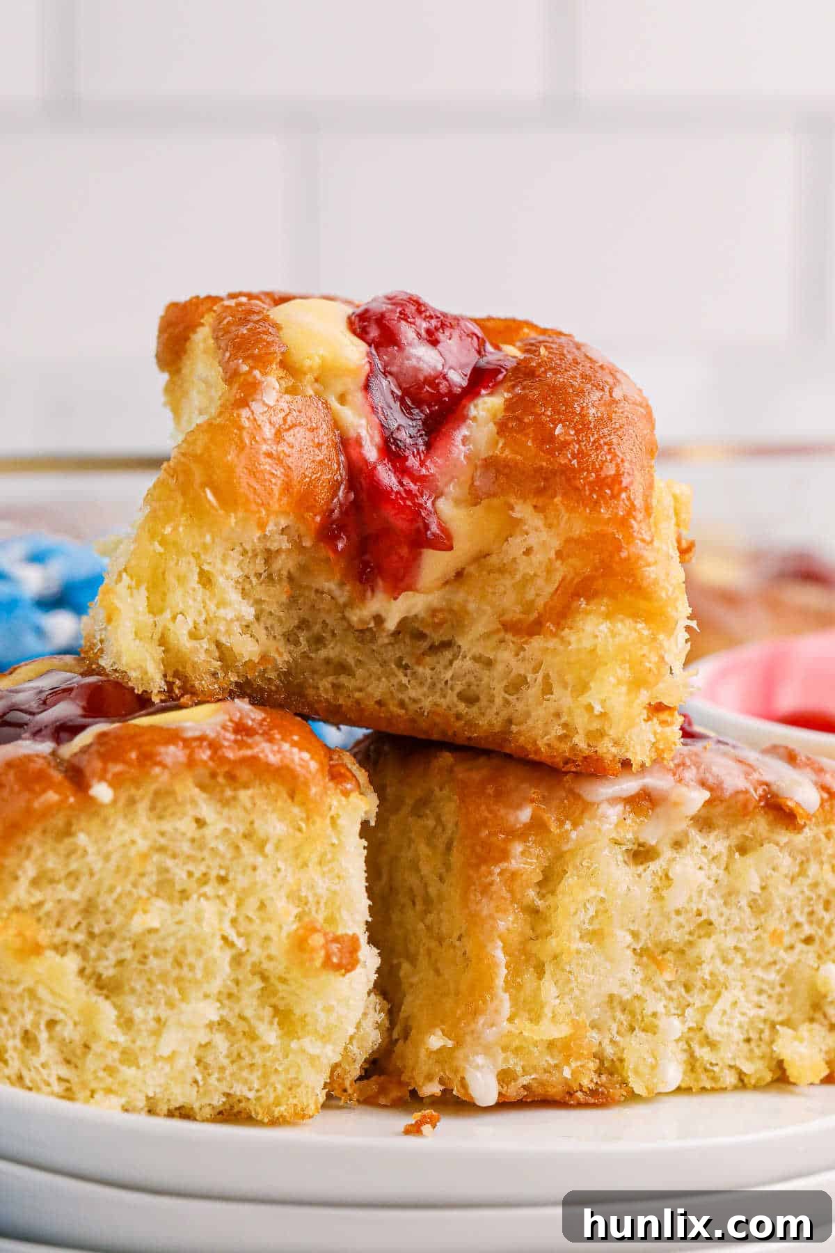 Cherry Hawaiian Danishes on a plate, garnished with fresh cherries.