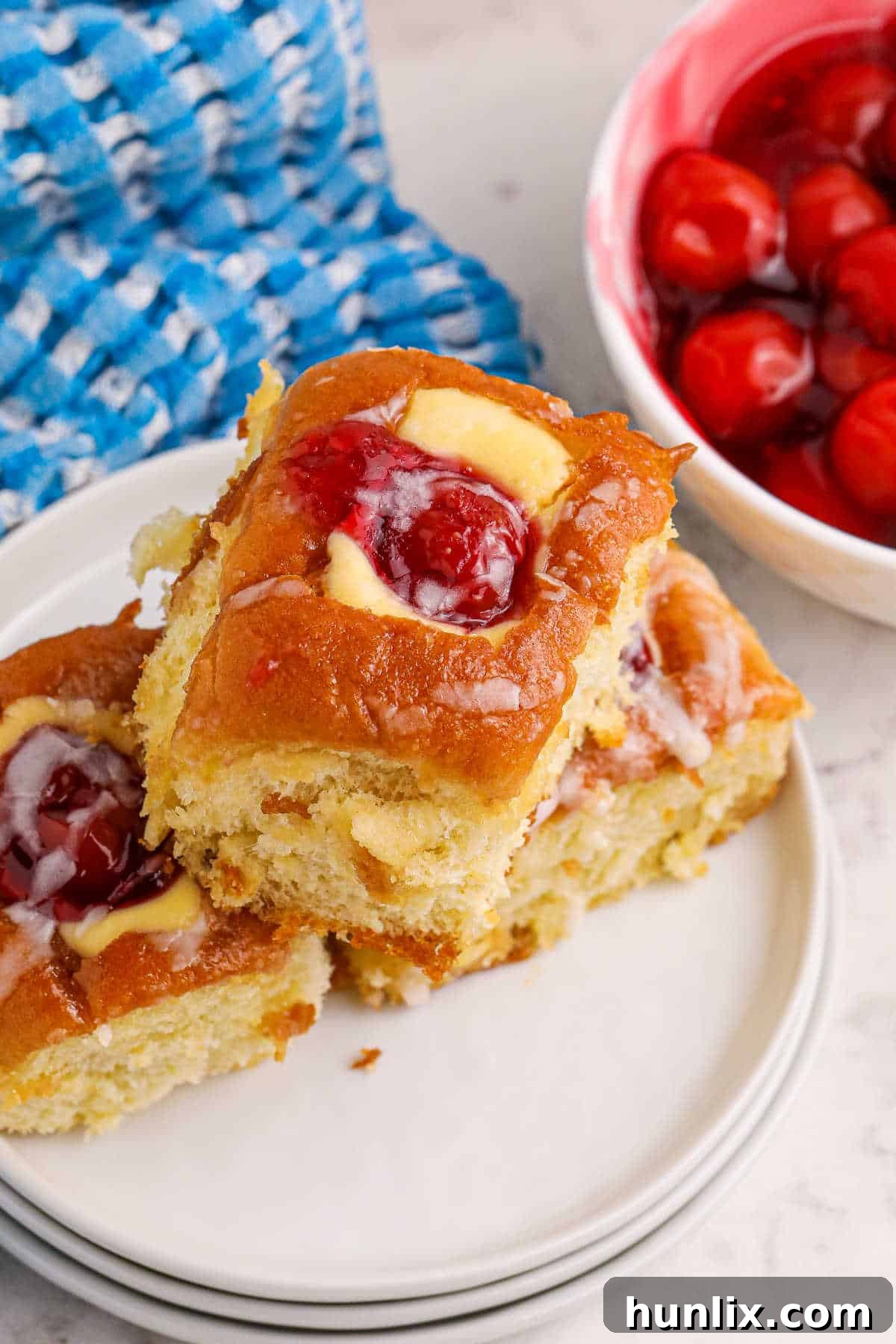 Cherry Hawaiian Danishes on a plate, showing the creamy filling and cherry topping.