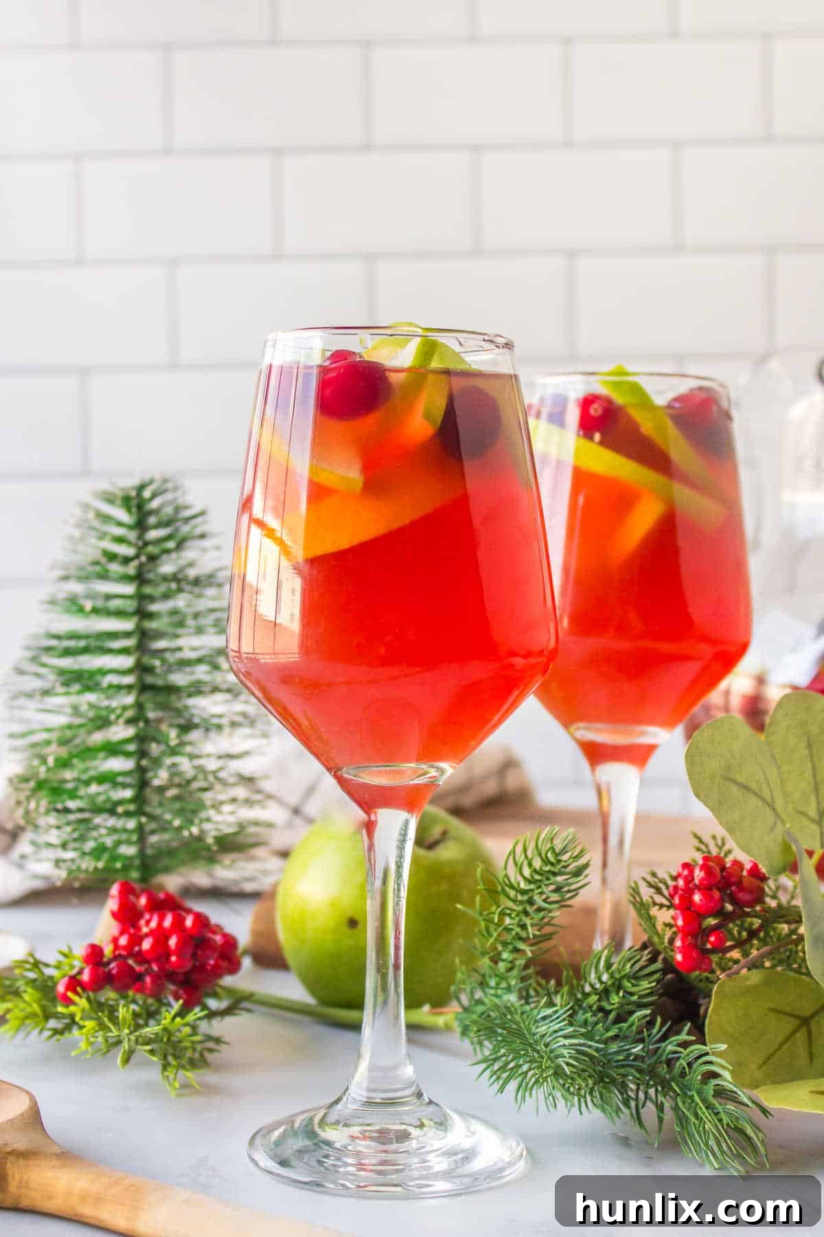 Multiple glasses of Holiday Sangria arranged for a party setting.