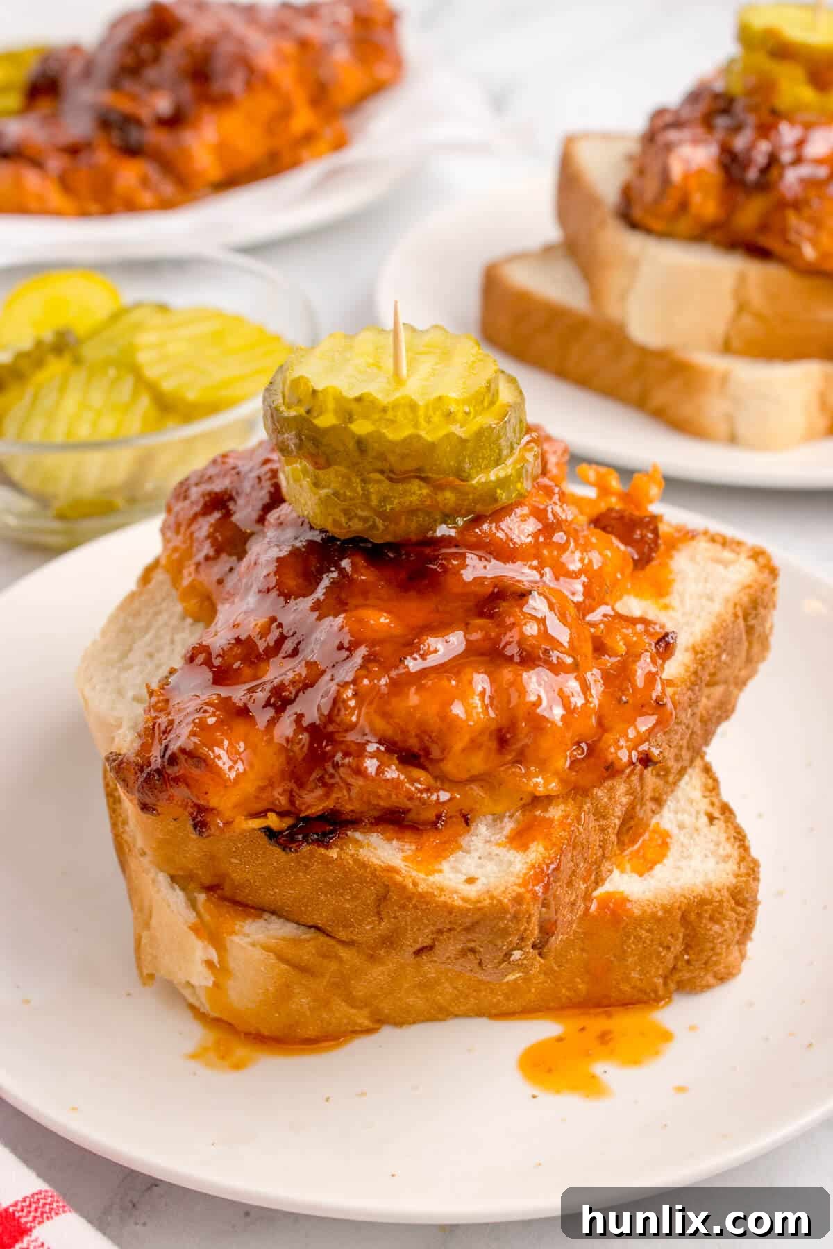 Crispy Air-Fried Nashville Heat 2 Air fryer Nashville Hot Chicken on a plate, showcasing its crispy skin and rich color.