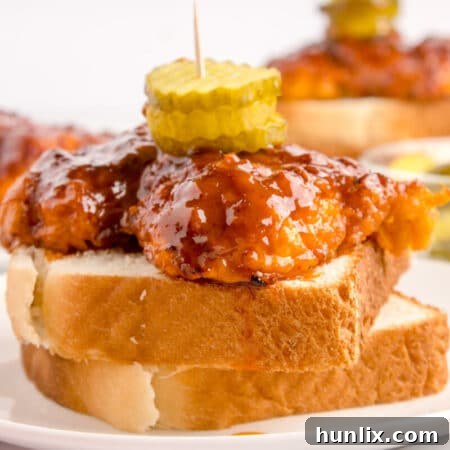 Crispy Air-Fried Nashville Heat 11 A plate of Air Fryer Nashville Hot Chicken, showcasing a golden crispy exterior.