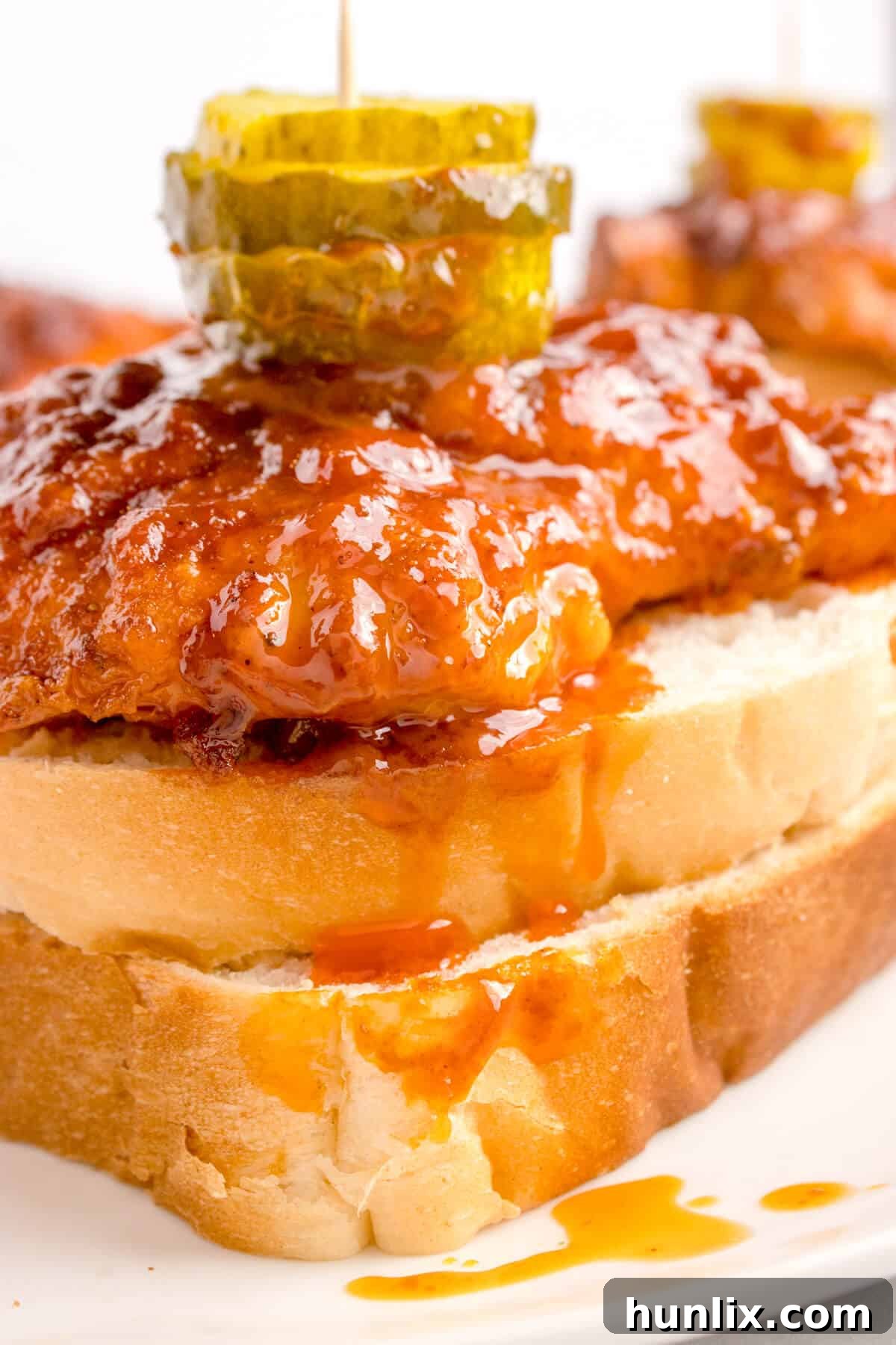 Crispy Air-Fried Nashville Heat 8 A close-up view of the Air Fryer Nashville Hot Chicken dish, showcasing its appealing texture and glaze.