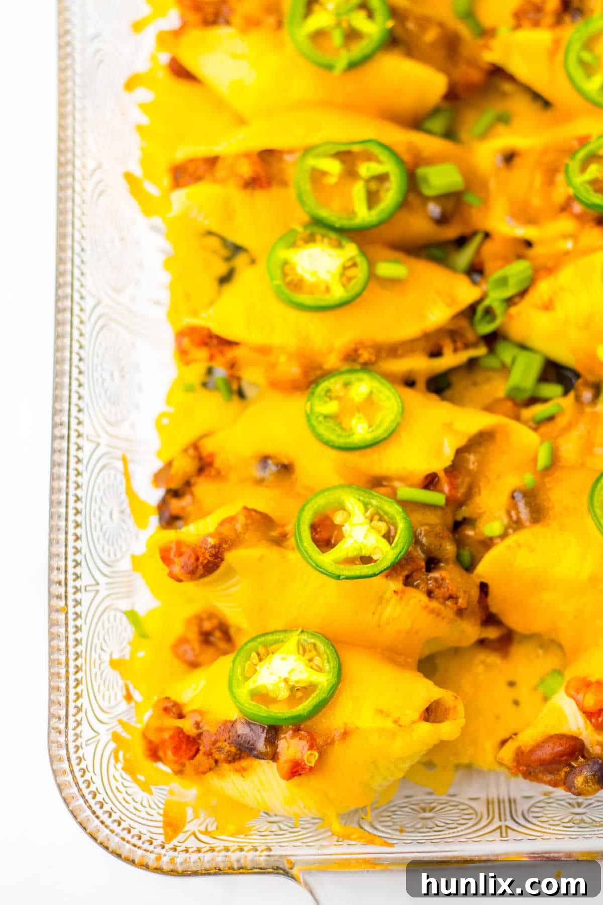 Chili cheese stuffed shells in a pan, ready to be served.