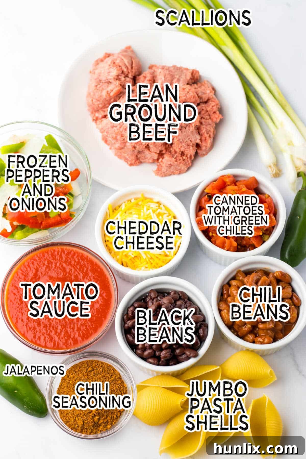 A selection of fresh ingredients including ground beef, canned goods, and cheese, ready to make chili cheese stuffed shells.