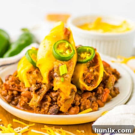 Chili cheese stuffed shells on a plate, garnished.
