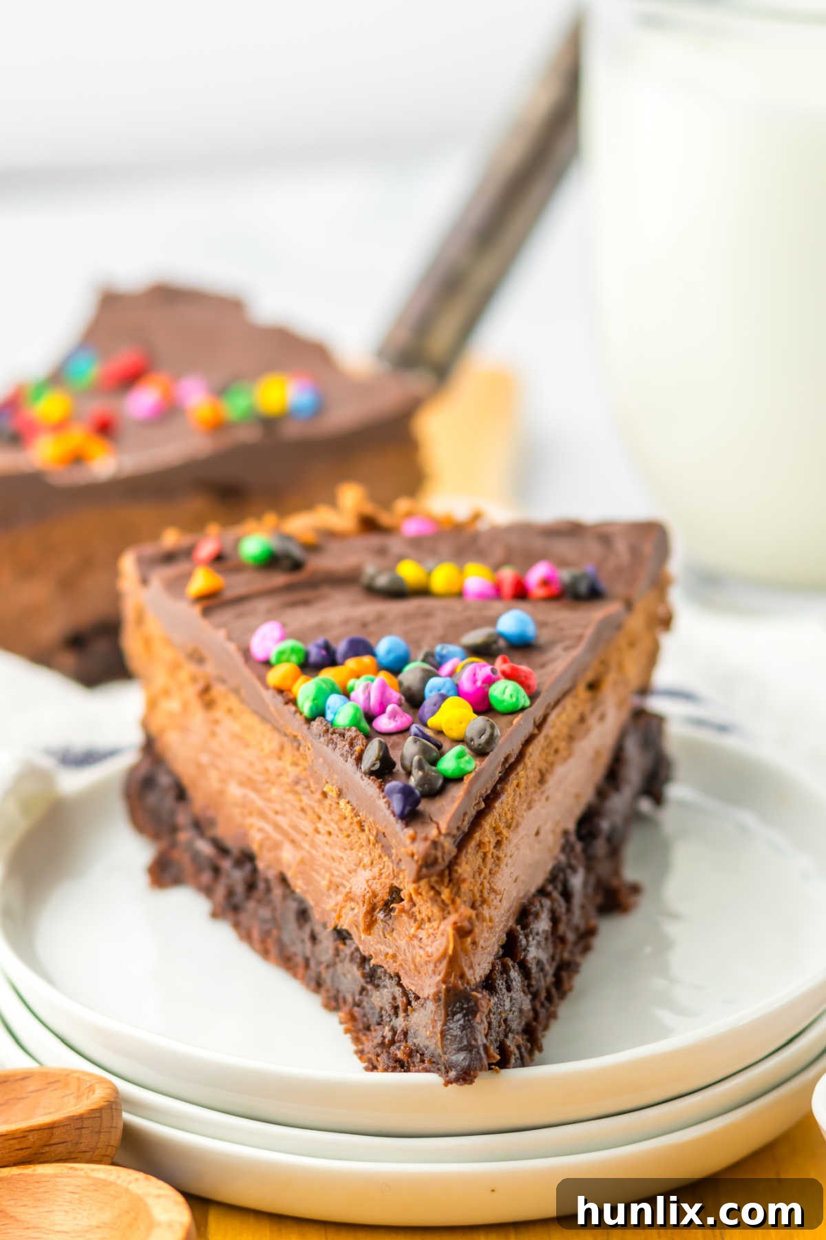 Brownie Nebula Cheesecake 8 A perfectly portioned slice of Cosmic Brownie Cheesecake served on a white plate, ready to be enjoyed.