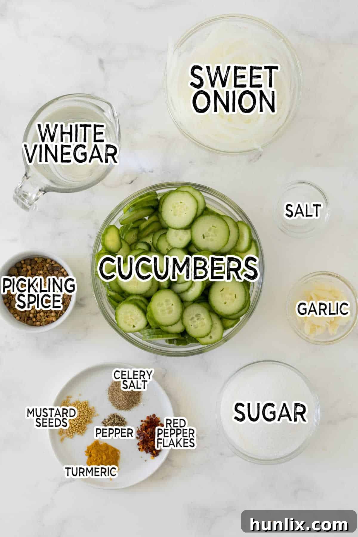 Quick and Easy Refrigerator Bread and Butter Pickles 3 Various fresh ingredients laid out on a surface, ready to be used for making bread and butter pickles.