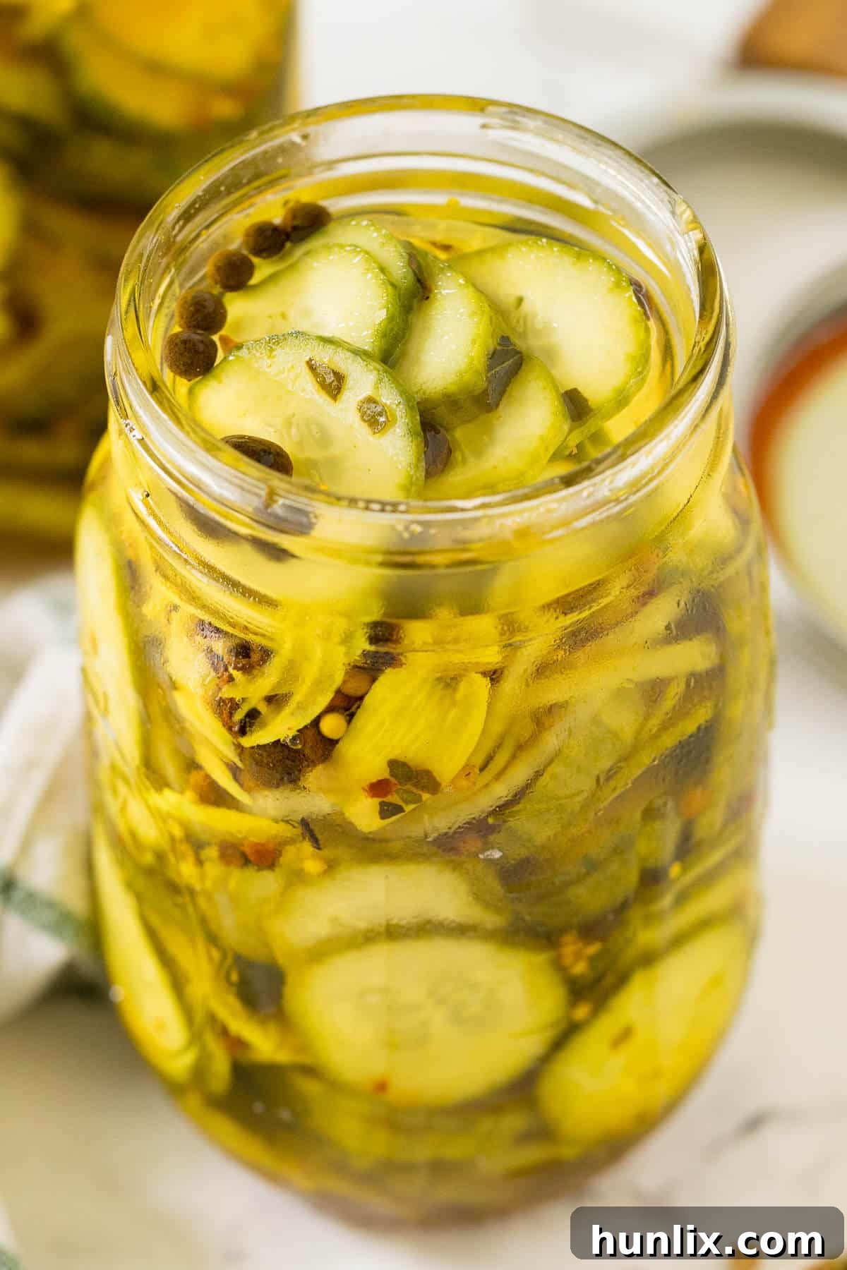 Quick and Easy Refrigerator Bread and Butter Pickles 6 A large mason jar brimming with golden refrigerator bread and butter pickles, ready to be served.
