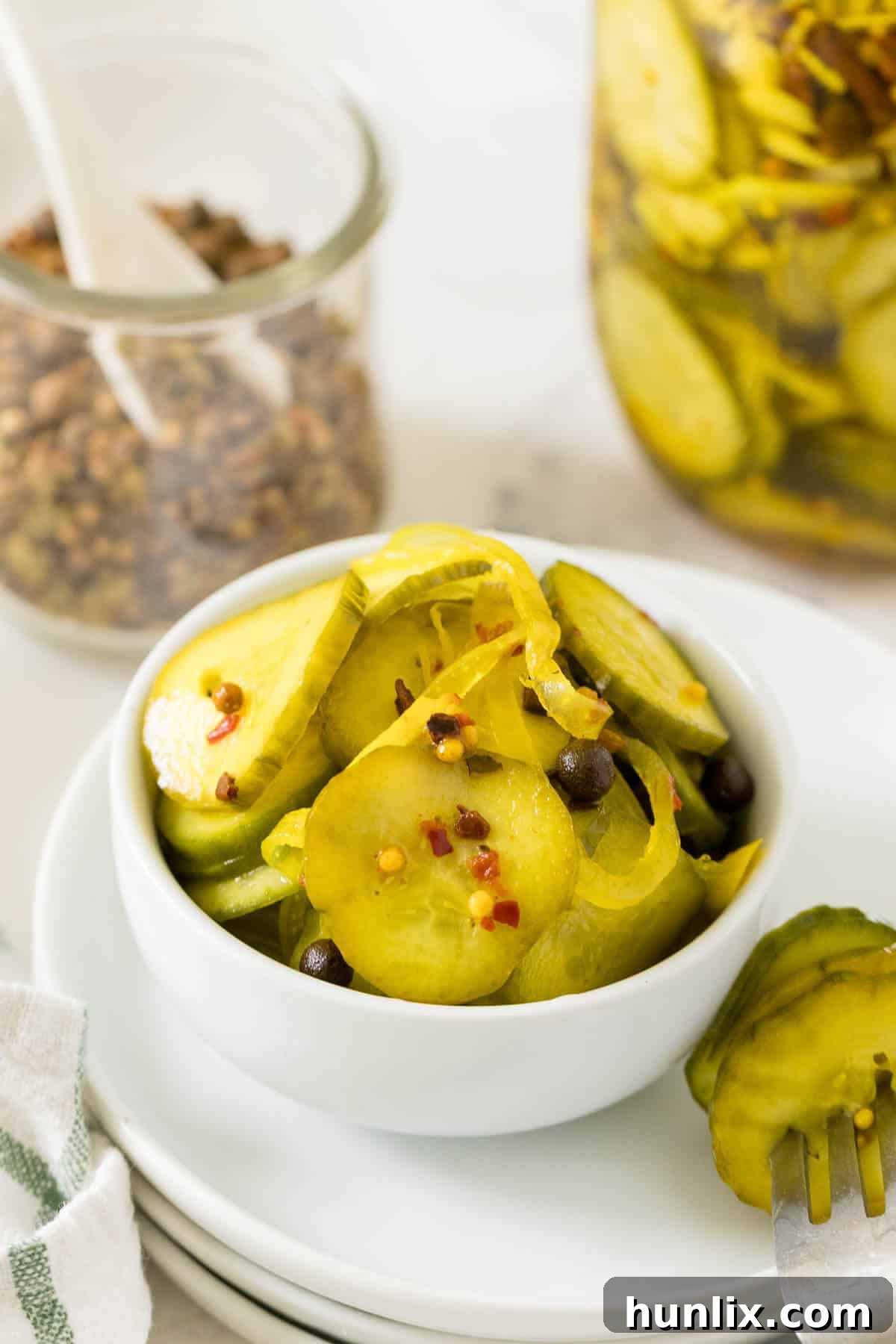 Quick and Easy Refrigerator Bread and Butter Pickles 7 A bowl filled with golden-brown refrigerator bread and butter pickles, ready to be enjoyed.
