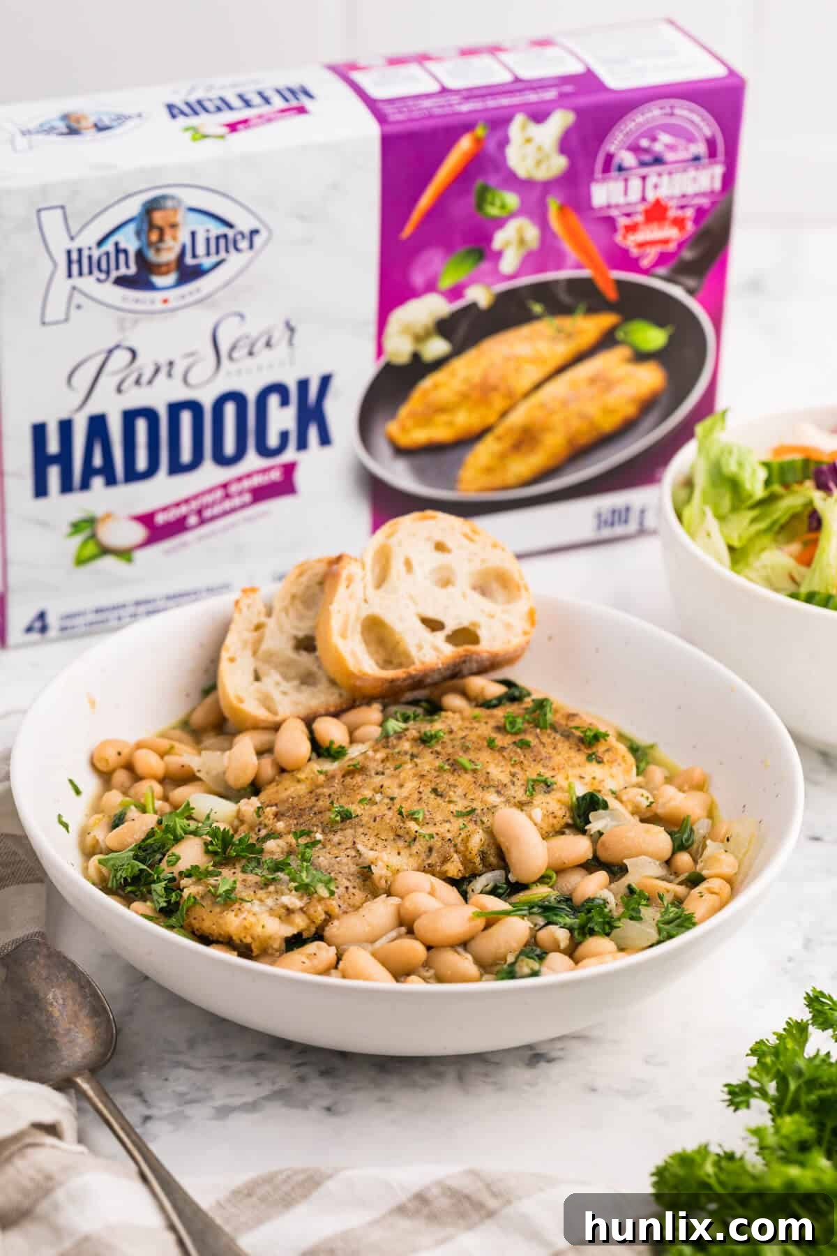 A beautifully plated bowl of High Liner Haddock with spinach and white bean ragout.