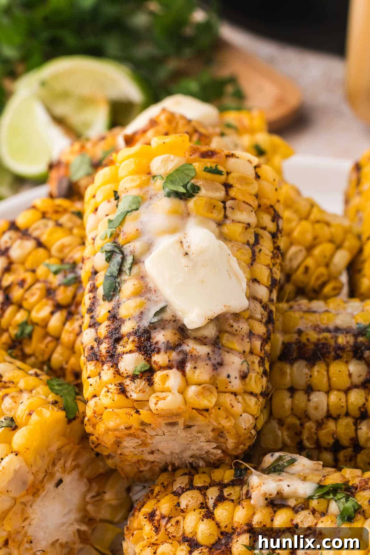 Golden air fryer corn on the cob generously topped with melted butter, ready to serve.