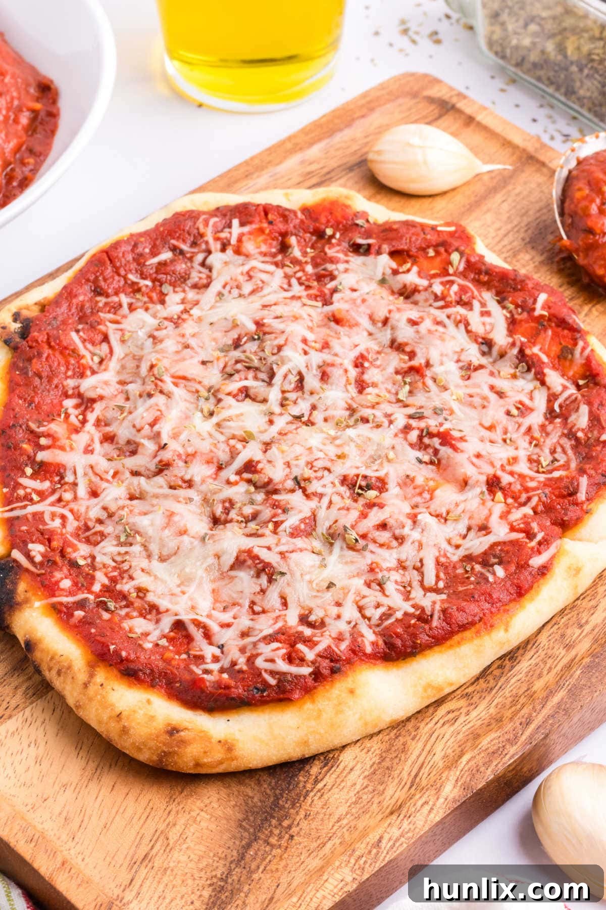 A freshly baked homemade pizza on a wooden cutting board, ready to be served.
