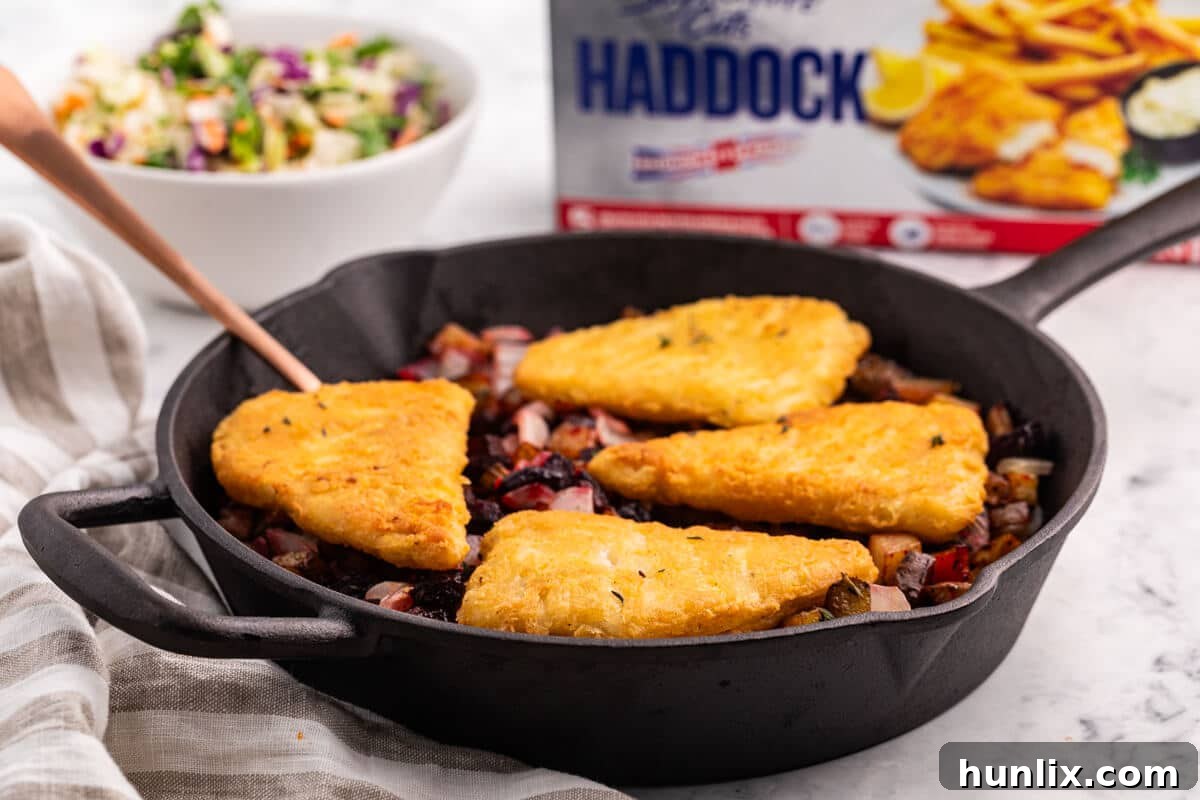 Pan-Seared Fish with Ruby Root Hash 5 Fish with Beet and Potato Hash with a serving spoon, ready to be dished out.