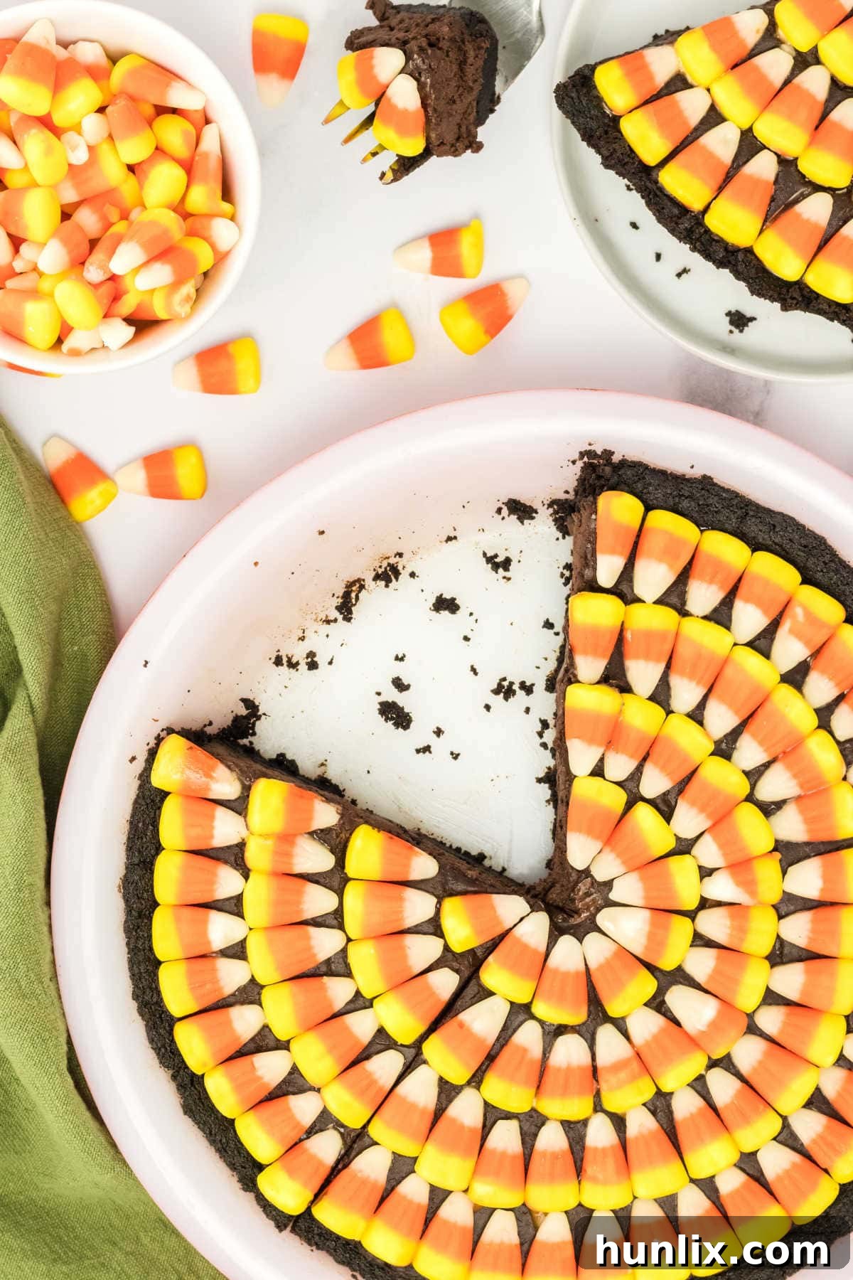 The Candy Corn Pie in its pan with a single slice already removed, showing the rich interior.