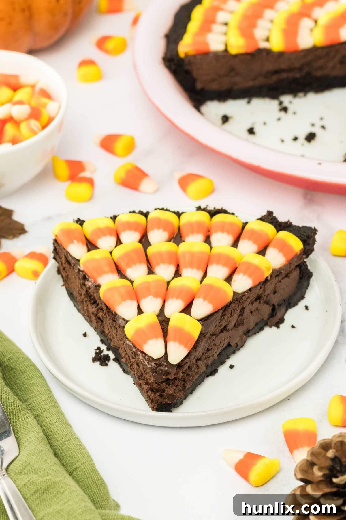 A close-up shot of a slice of Candy Corn Pie on a plate, highlighting its textures.