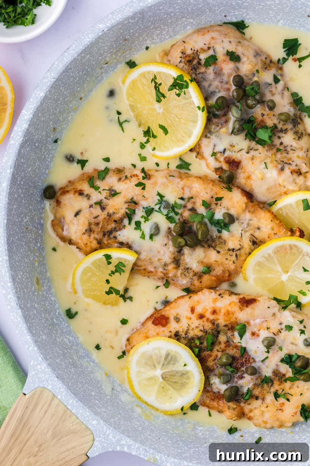 Lemon chicken piccata in a pan, ready to serve.