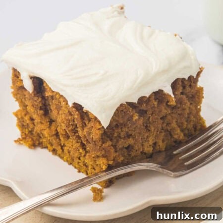 A piece of cake on a plate with a fork.