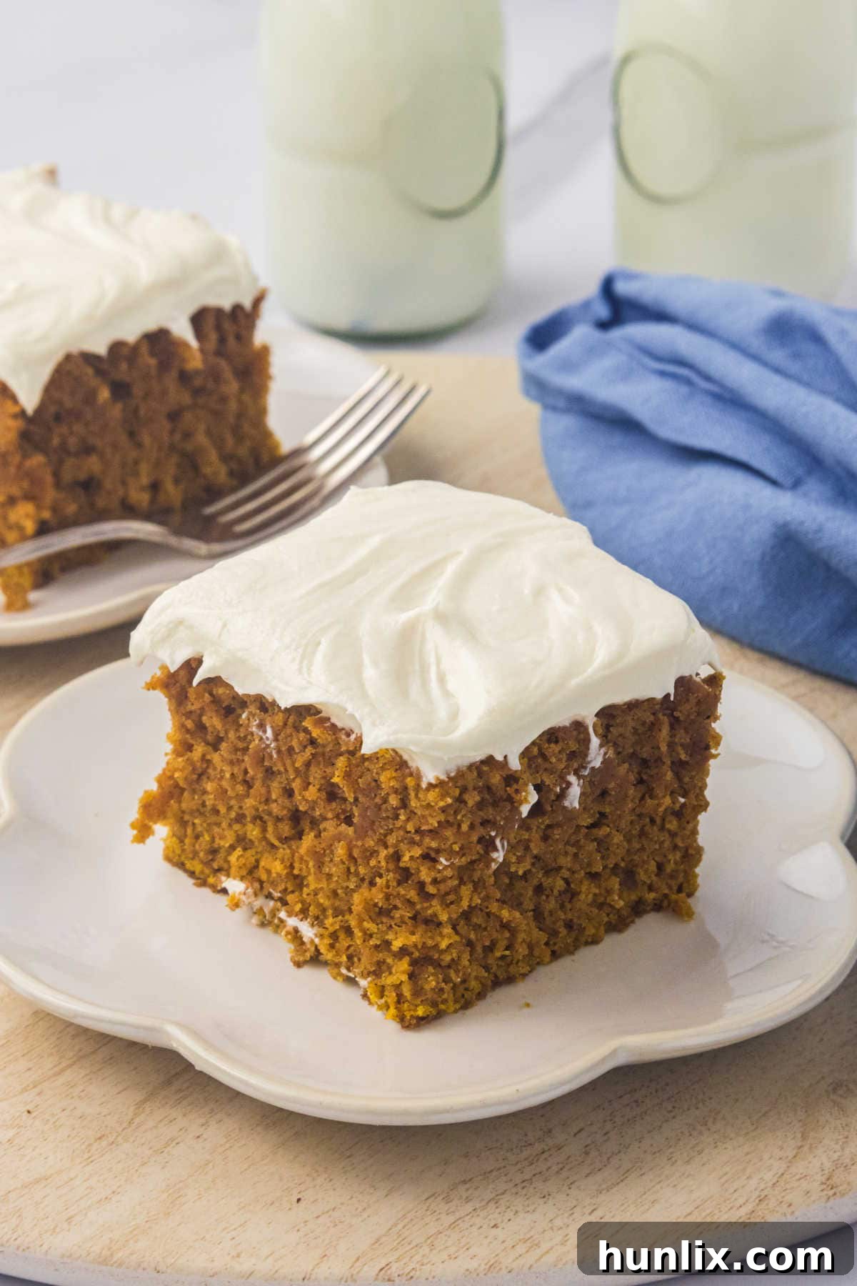 A slice of cake on a white plate.