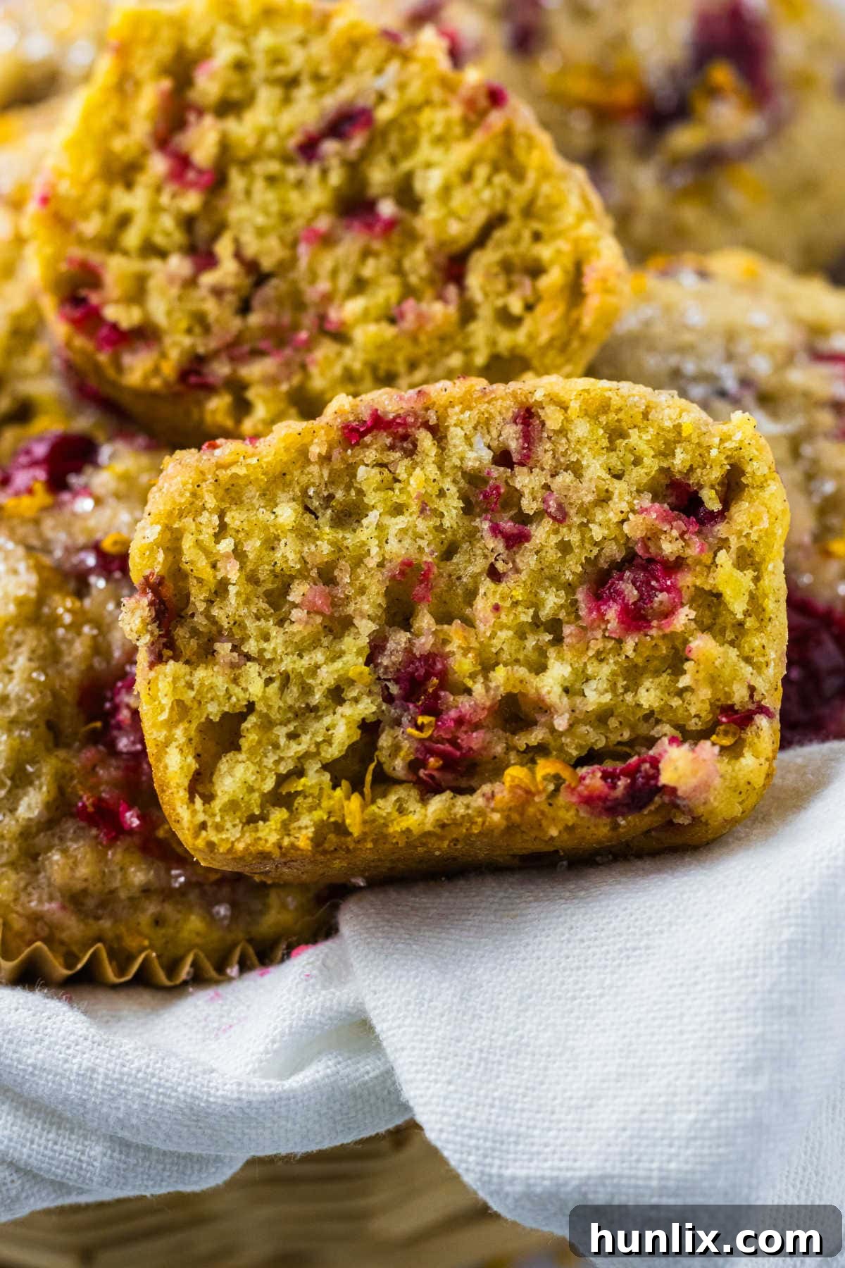 Zesty Cranberry Orange Muffins 9 A cranberry orange muffin cut in half to show the inside texture.
