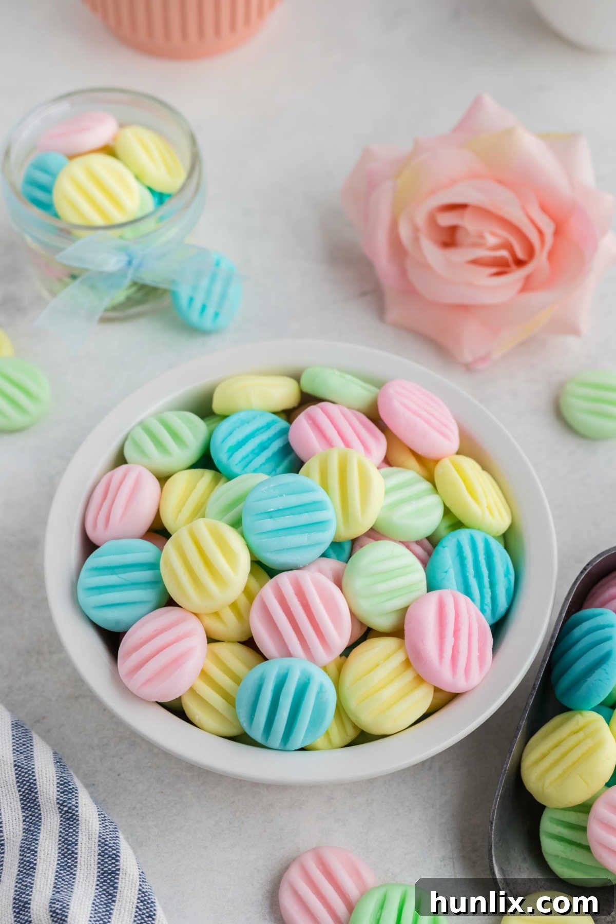 A delicate pile of pastel cream cheese mints in a decorative bowl, ready to be served at a party or special event.