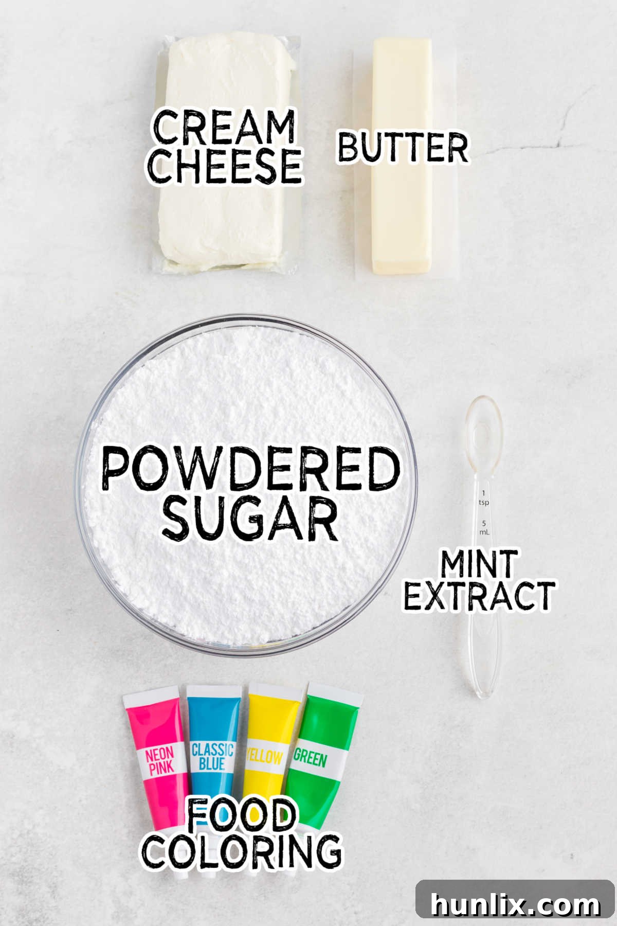 Ingredients for cream cheese mints: cream cheese, butter, powdered sugar, peppermint extract, and food coloring on a clean white surface.