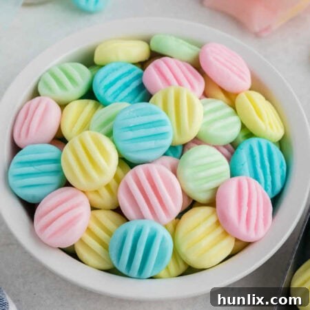A bowl of cream cheese mints, neatly arranged and ready for serving.