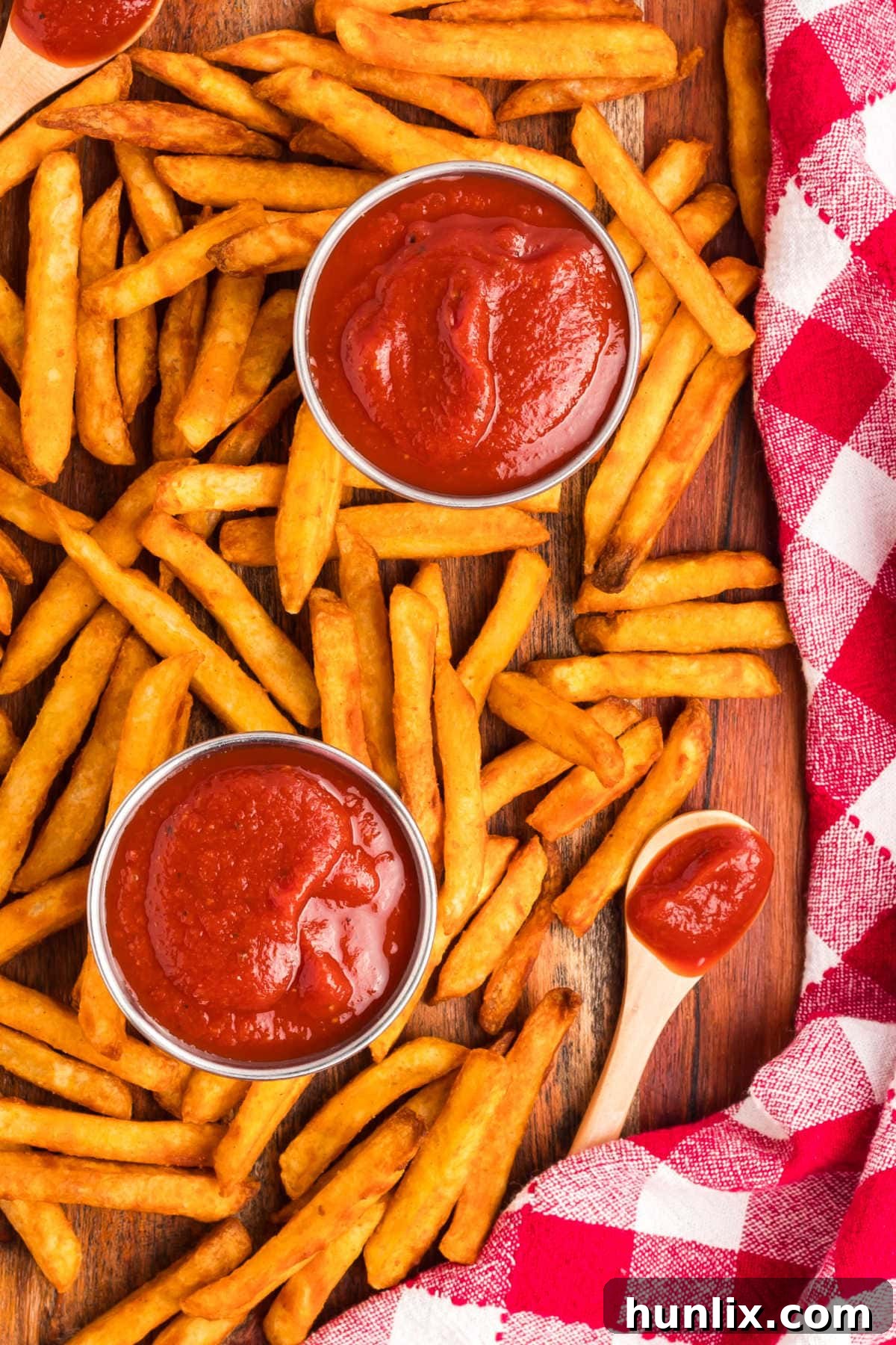 French fries on a wooden cutting board with the recipe.
