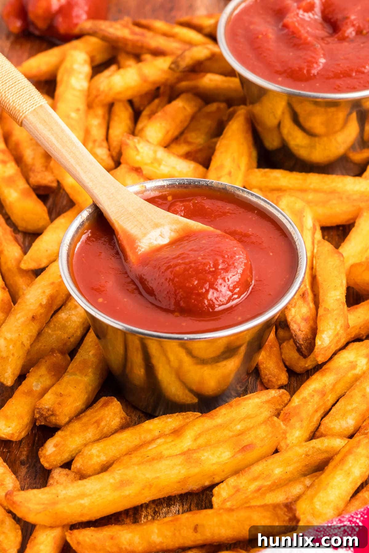 A wooden spoon in a container of the recipe.