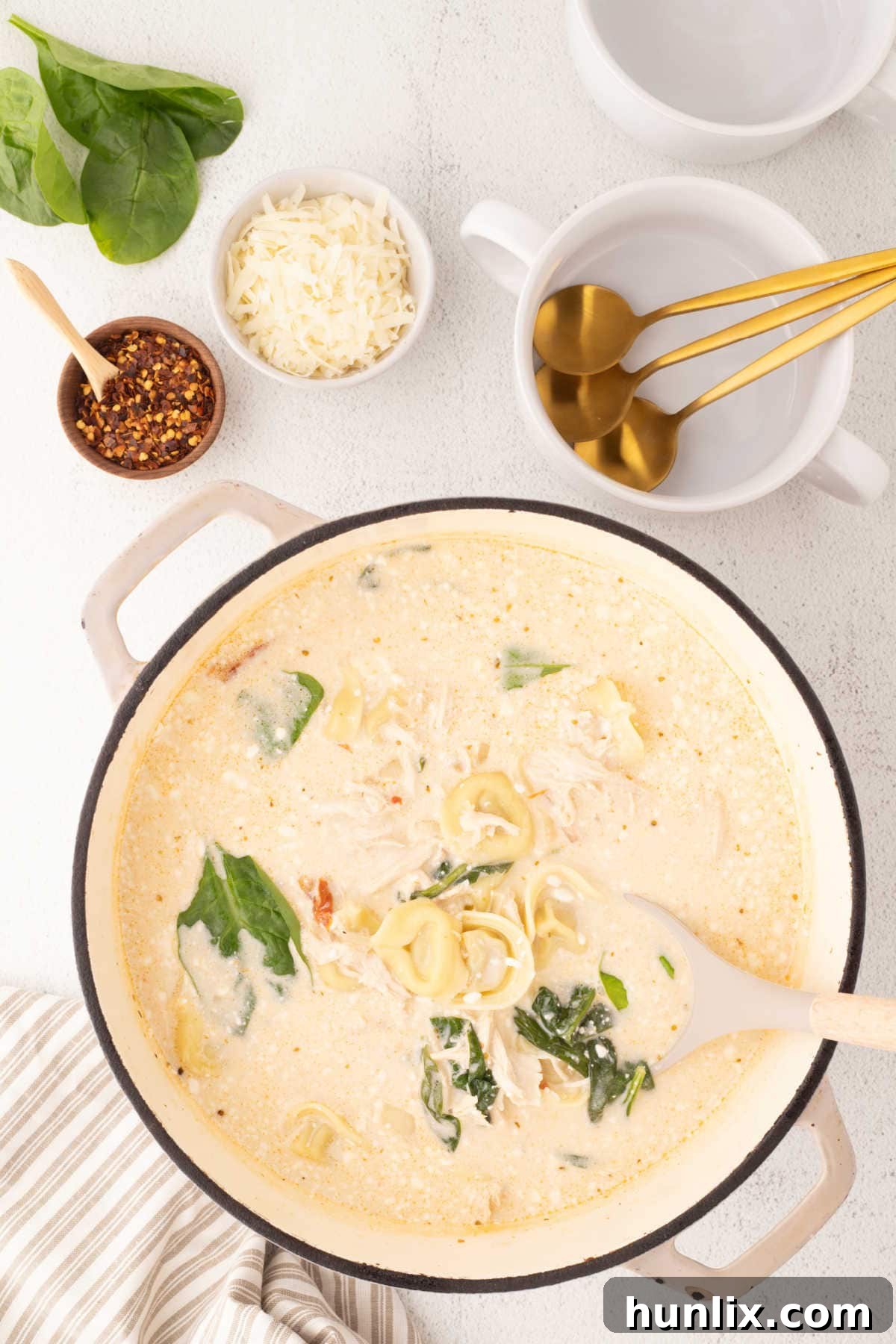 Soulmate Chicken Soup 6 A large pot filled with Marry Me Chicken Soup, ready to be served, with a ladle resting in it.