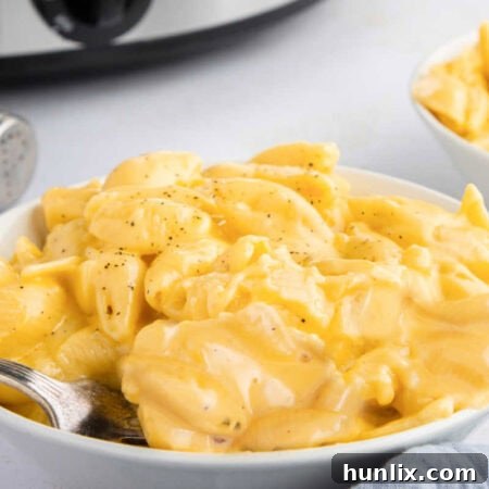 Creamy Slow Cooker Velveeta Mac and Cheese 9 The recipe on a plate with a fork.