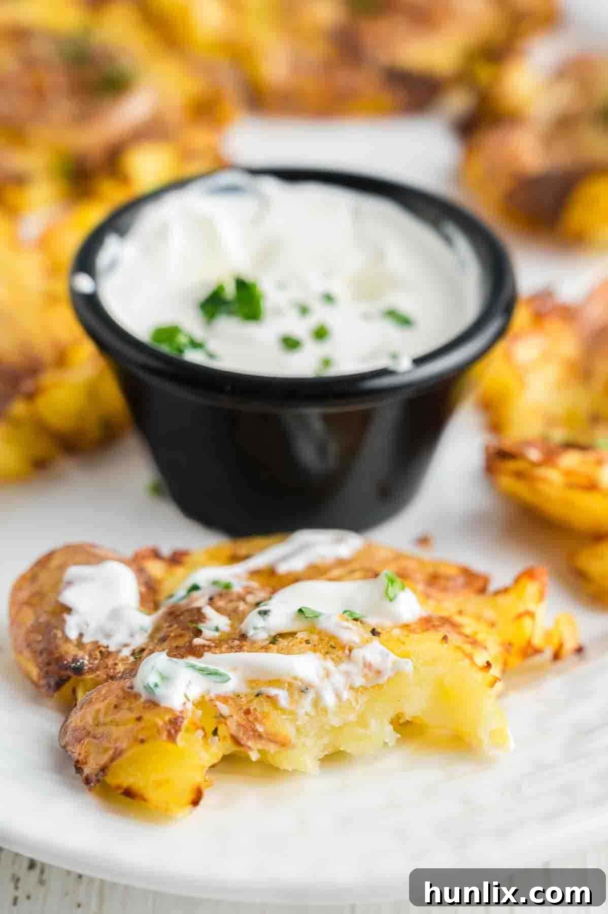 The recipe on a plate topped with sour cream.