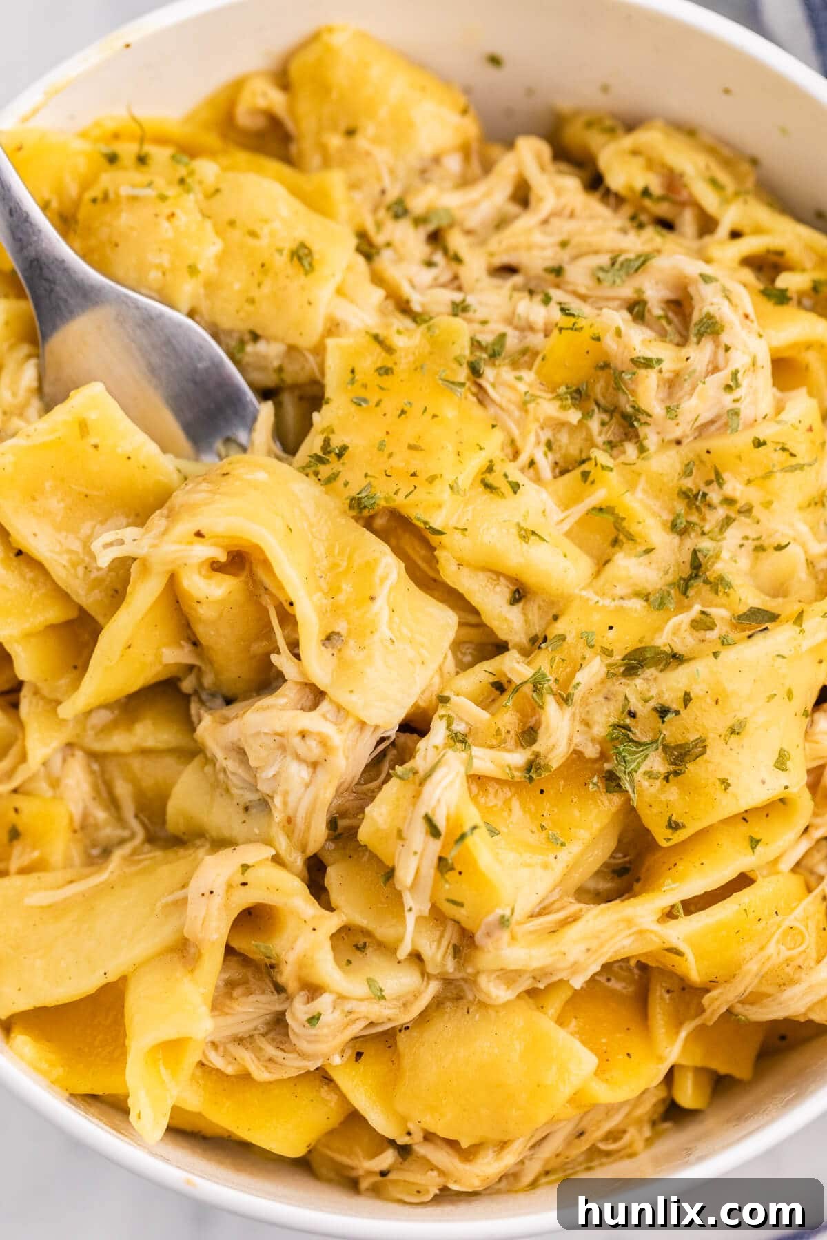 The recipe in a white bowl with a fork.