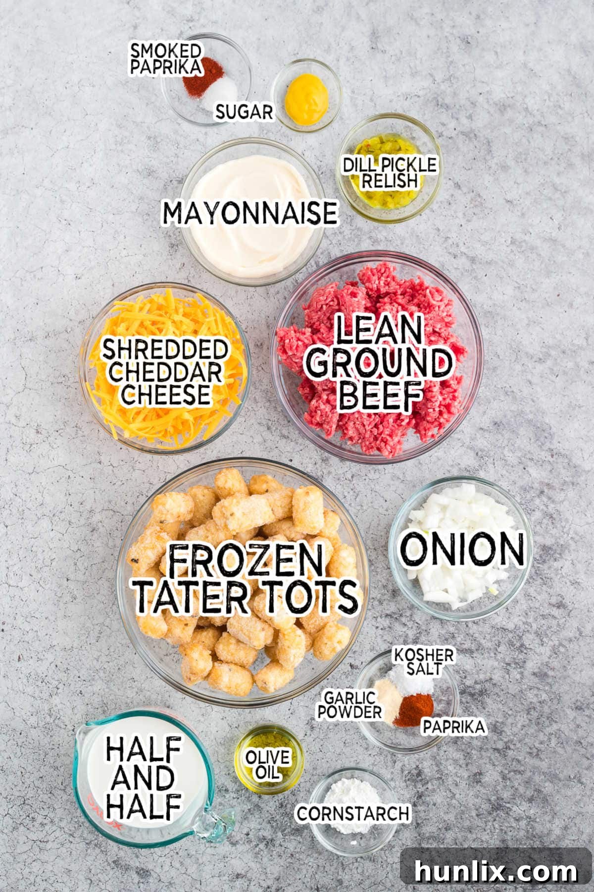 Loaded Big Mac Tater Tot Casserole 3 Assortment of fresh ingredients for Big Mac Tater Tot Casserole on a grey background.