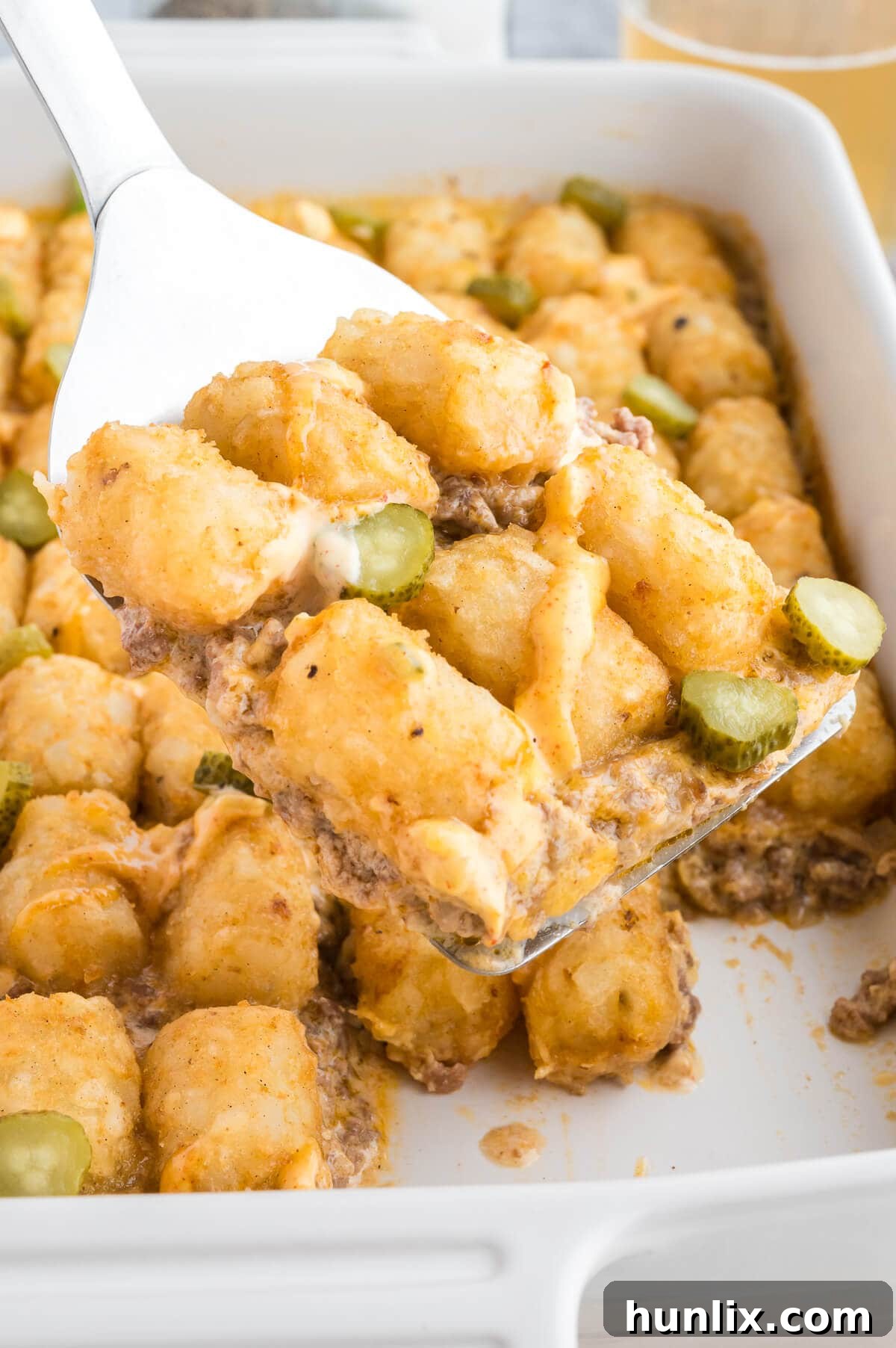 Loaded Big Mac Tater Tot Casserole 8 A slice of Big Mac Tater Tot Casserole being lifted with a spatula, showing the layers.