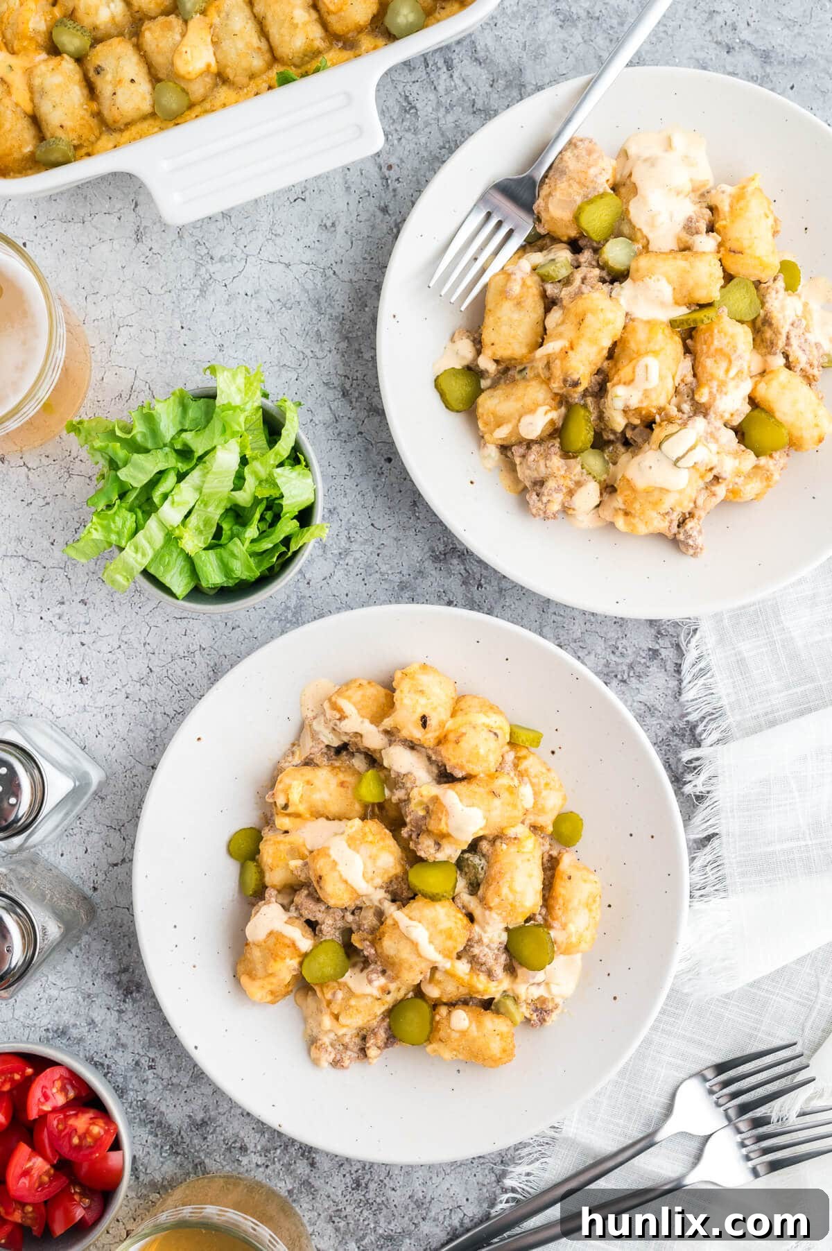 Loaded Big Mac Tater Tot Casserole 9 Plates of Big Mac Tater Tot Casserole, garnished with fresh toppings.