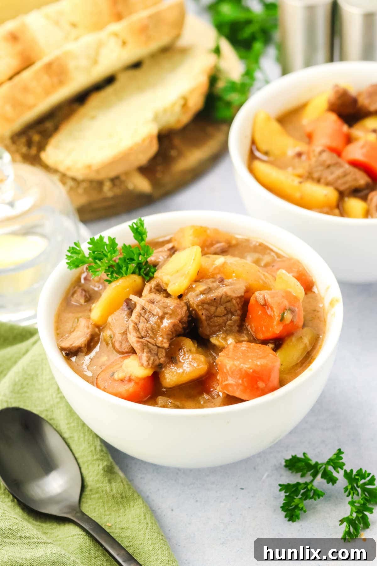 A generous bowl of Slow Cooker Guinness Irish Beef Stew, garnished with fresh herbs.