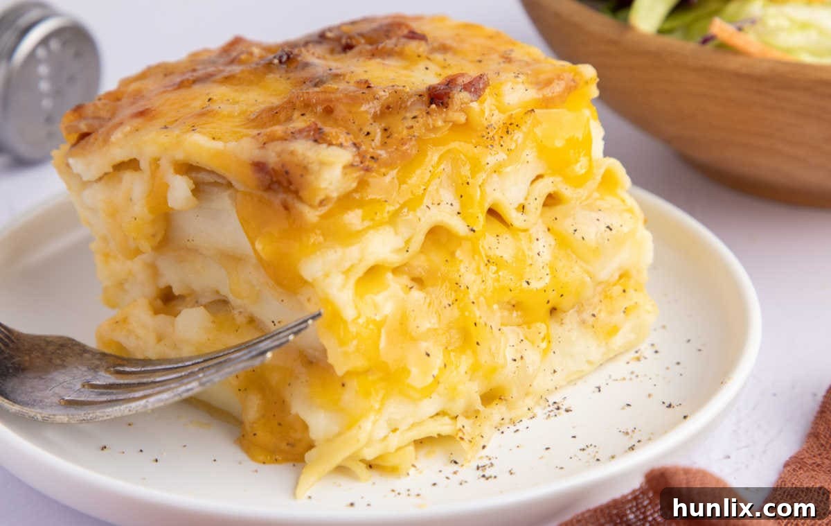 A perfectly cut slice of pierogi lasagna on a plate, ready to be eaten.