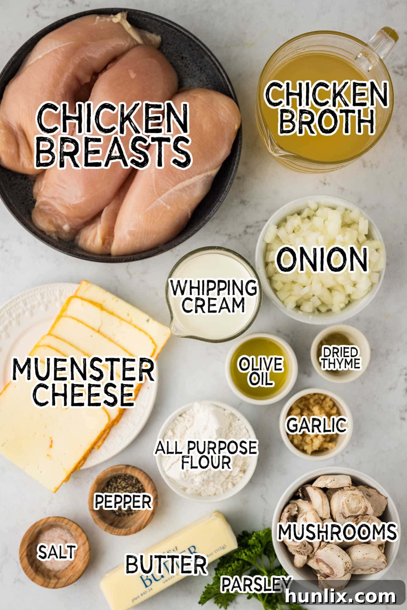 All the raw ingredients for Chicken Gloria laid out on a marble counter.