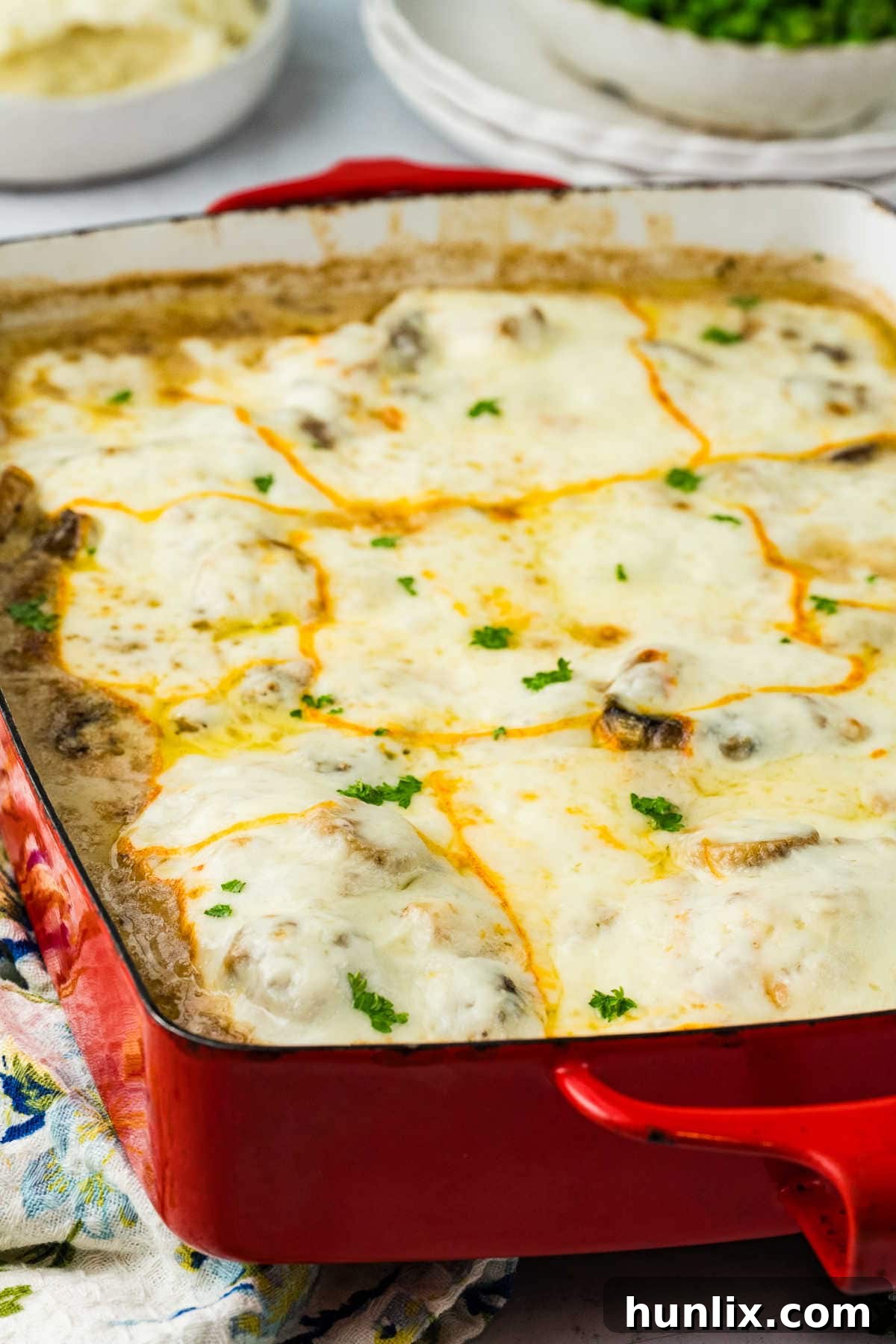 Chicken Gloria served in a red baking dish.