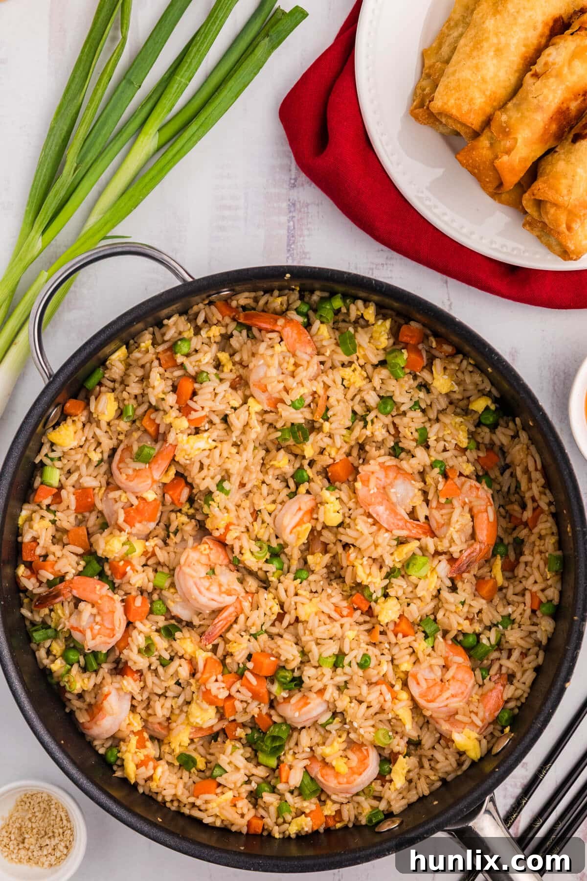 A vibrant pan of freshly cooked shrimp fried rice, steaming and ready to serve.