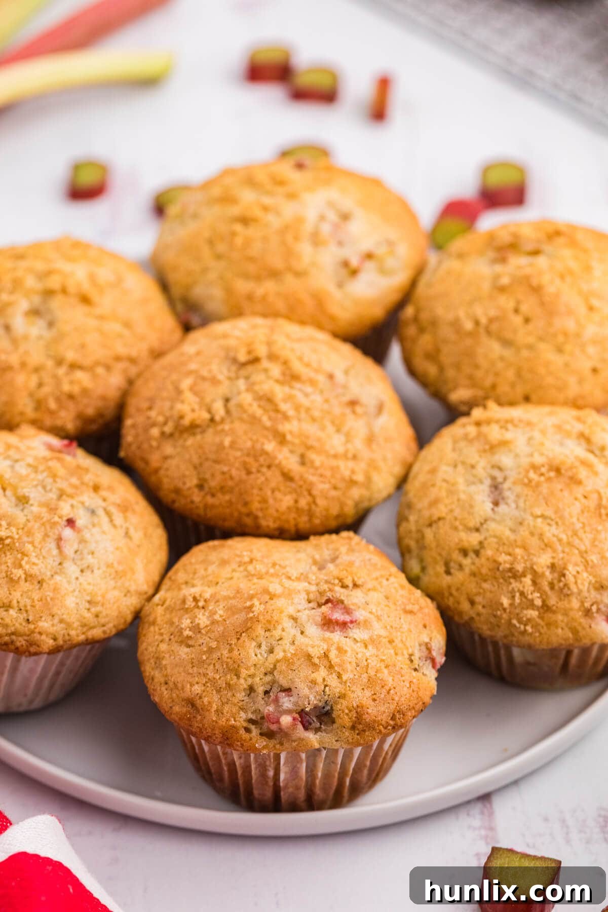 Freshly baked rhubarb muffins on a plate, ready to be enjoyed.