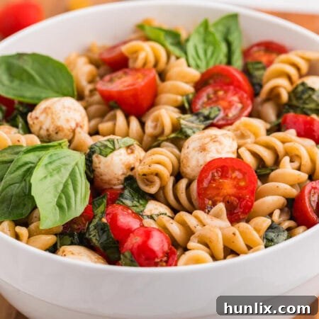 A beautifully presented bowl of Caprese Pasta Salad, ready to be served.